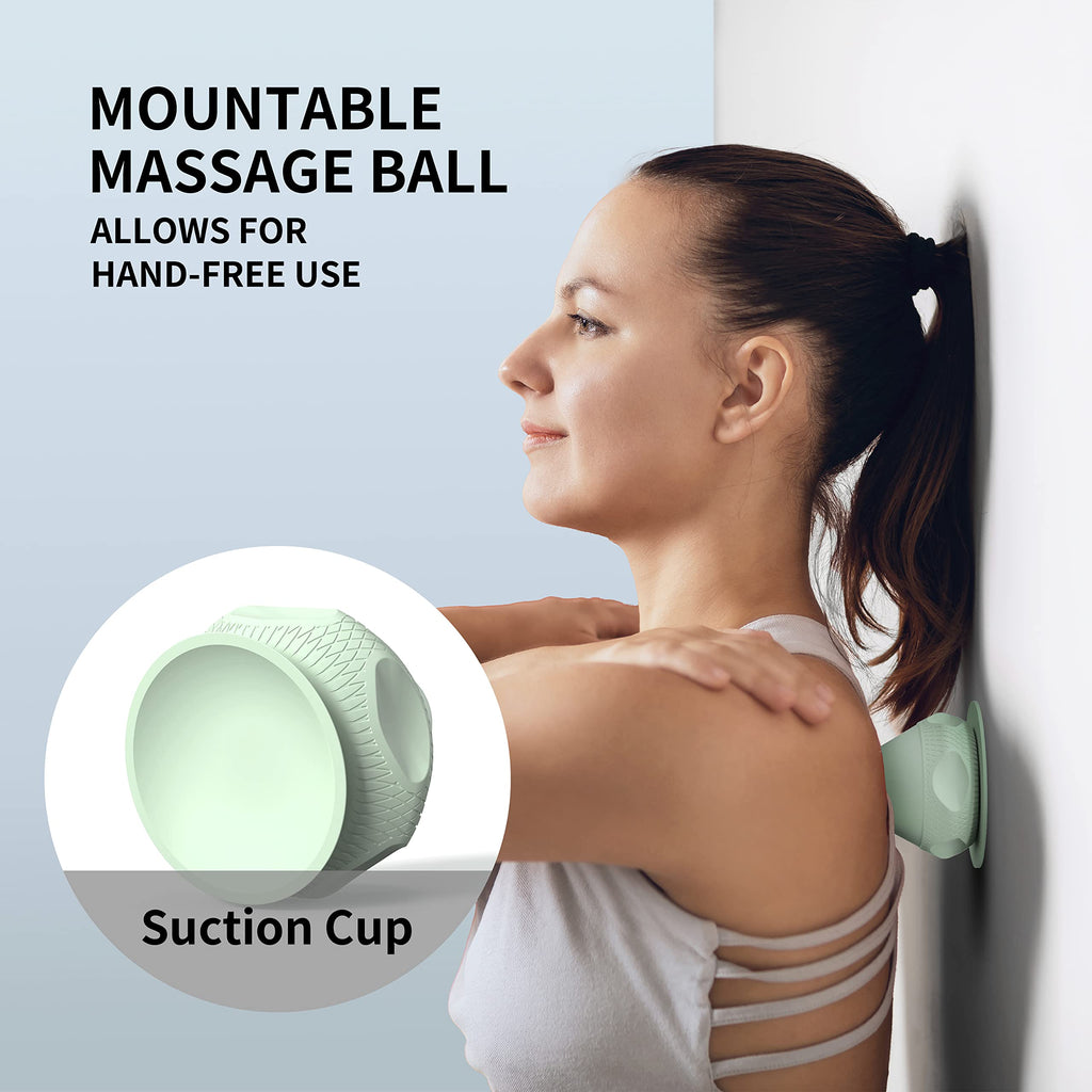 Green PROIRON suction cup massage ball positioned against a smooth wall for shoulder self-massage