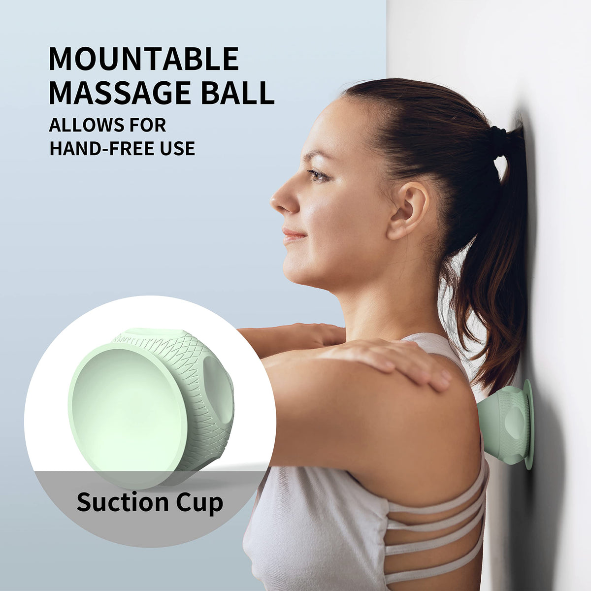 Green PROIRON suction cup massage ball positioned against a smooth wall for shoulder self-massage